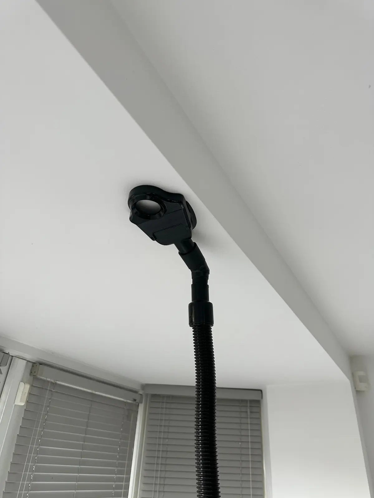 XtraHand V2 prototype retained on an overhead surface during vacuum-suction testing