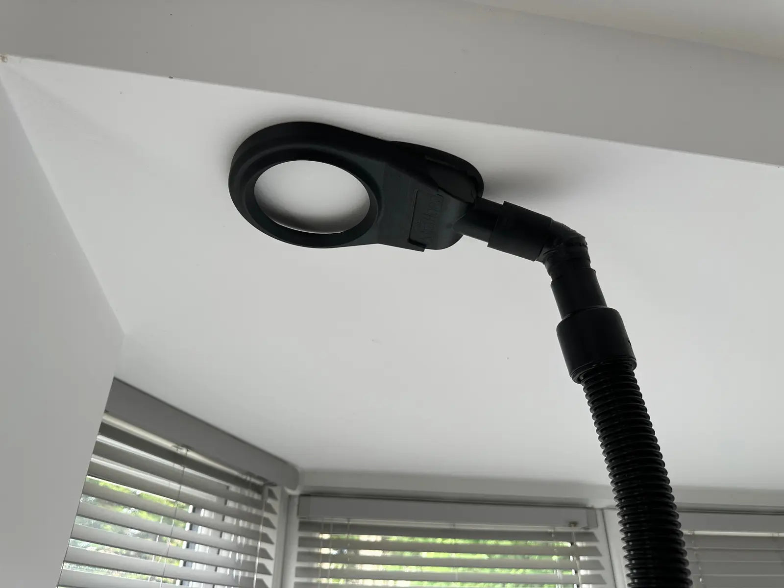 Larger-capacity XtraHand V2 prototype attached to a ceiling by vacuum suction