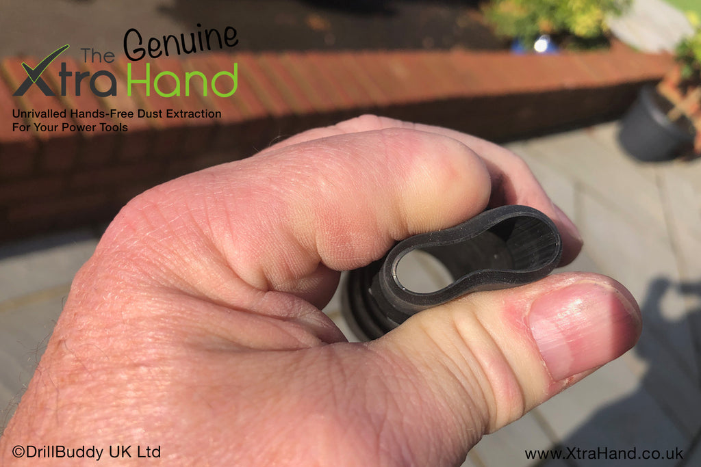 Close-up of the Genuine XtraHand® Professional Flexible Hose Adapter being compressed by hand to demonstrate its pliable rubber construction. The flexible design provides a tighter, stress-free fit to a wide range of vacuum hoses, dust extractors and compatible power tools.