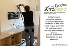 Installer using the Genuine XtraHand® hands-free dust extraction tool while drilling into a wall with both hands on the power drill. The XtraHand captures dust at source, improving control, accuracy, visibility and safety during installation work.