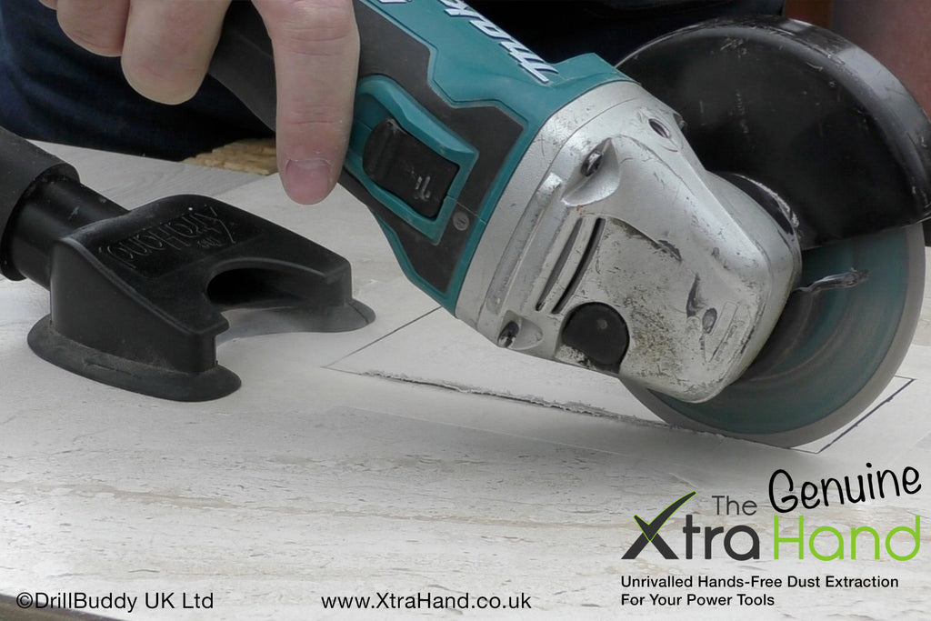 Using the Genuine XtraHand® hands-free dust extraction tool with a 125mm angle grinder to cut a ceramic tile aperture for a bathroom shaving socket. Captures tile dust at source to improve visibility, reduce airborne silica dust and keep the work area cleaner.