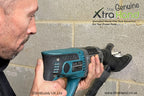 Pete using the Genuine XtraHand® hands-free dust extraction tool with a masonry drill to drill into a concrete block wall. Connected to a hose-mounted vacuum, the XtraHand captures dust and debris at source, improving visibility, reducing airborne dust and helping keep the work area cleaner.